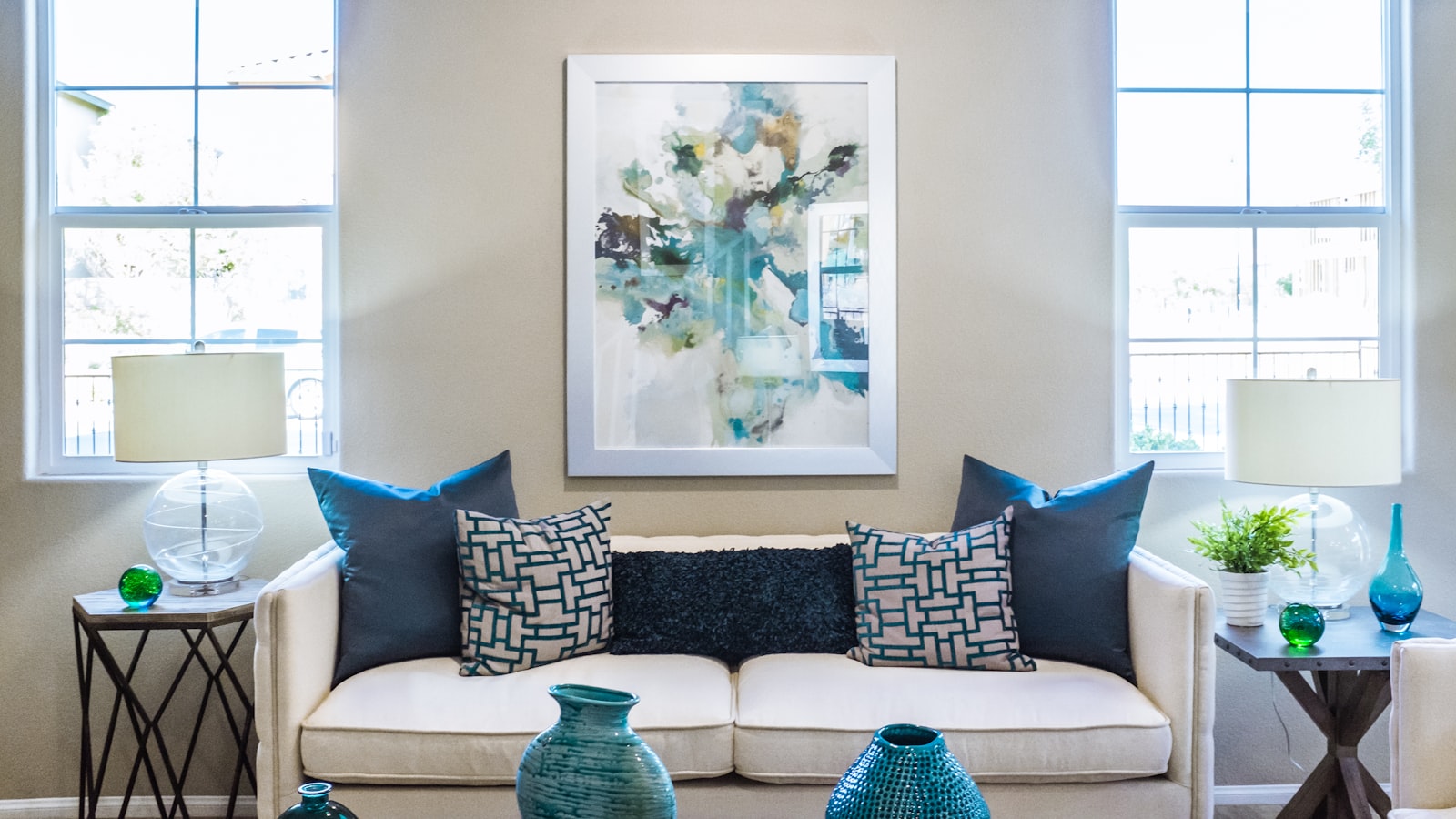 A calm, tidy living room with cushions straightened and surfaces clear in soft daylight