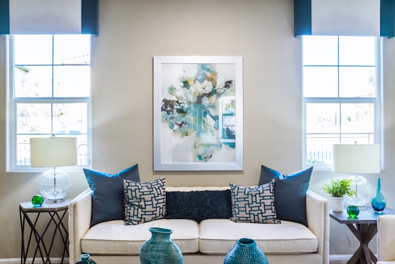 A calm, tidy living room with cushions straightened and surfaces clear in soft daylight