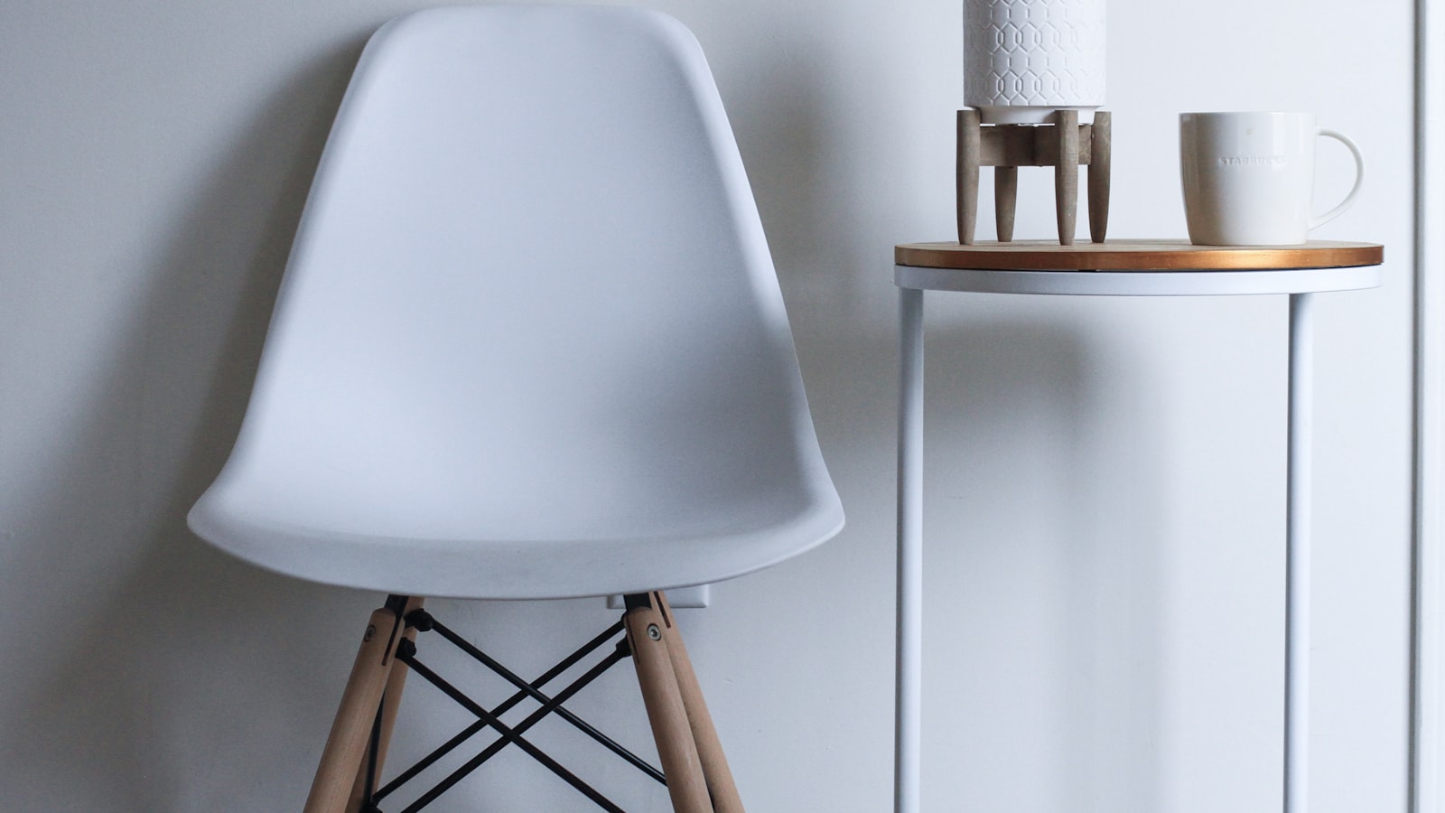 A cozy living room corner lit by a floor lamp and a small table lamp in the evening