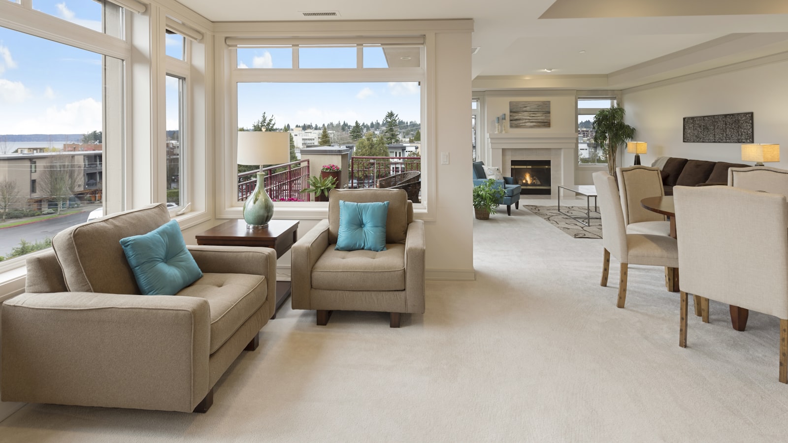 A compact living room with a slim sofa, a round coffee table, and a large mirror reflecting daylight
